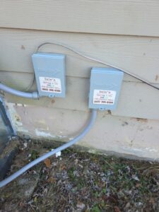 Two gray electrical boxes labeled 